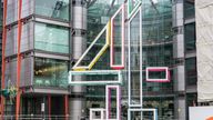 London, UK - Pedestrians on the street in front of the headquarters building of the UK television broadcaster Channel 4, located in Westminster.