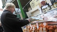 Conservative candidate for London Mayor Boris Johnson (left) during a walkabout in Borough Market, London.