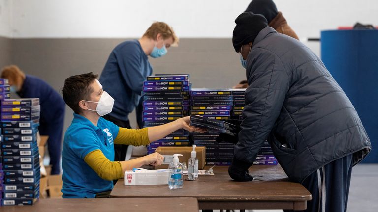 Free rapid at-home COVID testing kits are distributed at a vaccination clinic in Philadelphia