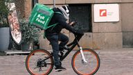 A courier working with Bolt Food, a meal delivery app service, rides a bike as he delivers an order from a restaurant during the coronavirus disease (COVID-19) outbreak, after Latvia's government declared a four-week lockdown under which restaurants can serve only takeaway food, in Riga, Latvia November 10, 2020