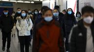 People walk at a subway station during morning rush hour in Beijing, China January 17, 2022