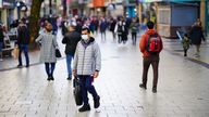 Shoppers walk through the centre of Cardiff