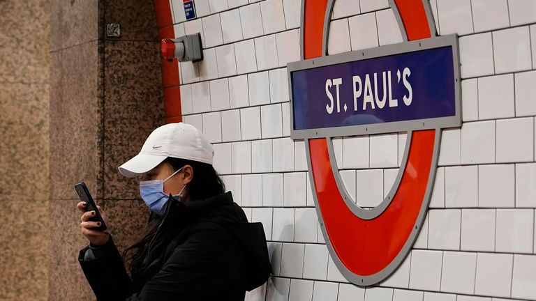 A woman wears a mask as she sits at St. Paul's Underground station, in London, Thursday, Dec. 16, 2021.  
PIC:AP