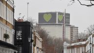 A message is seen on the covered remains of the Grenfell Tower, after it was announced Britain's government will seek an extra 4 billion pounds ($5.4 billion) from property developers to fund repairs to dangerous apartment blocks, in the wake of a fire that killed more than 70 people at Grenfell in 2017, in London, Britain, January 10, 2022. REUTERS/Toby Melville
