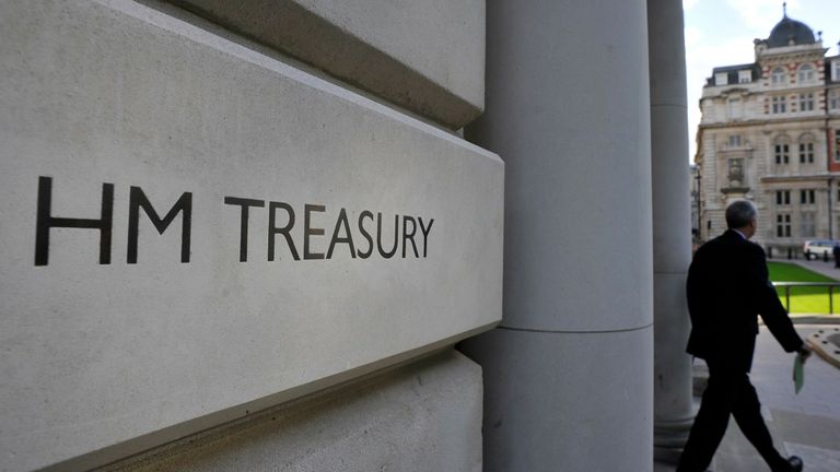 A man leaves the government Treasury buildings in Whitehall in central London October 19, 2010. Britain will delay spending on replacing its Trident submarine-based nuclear weapons system as part of sweeping cuts to the defence budget to help curb a record deficit, Prime Minister David Cameron said on Tuesday.  REUTERS/Toby Melville (BRITAIN - Tags: POLITICS BUSINESS)