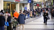 Boxing Day shoppers queue to enter shops in the centre of Cardiff, Wales, as new Covid-19 rules come into force. Groups of no more than six people will be allowed to meet in pubs, cinemas and restaurants in Wales, with two-metre social distancing being required in public premises and offices. Picture date: Sunday December 26, 2021.