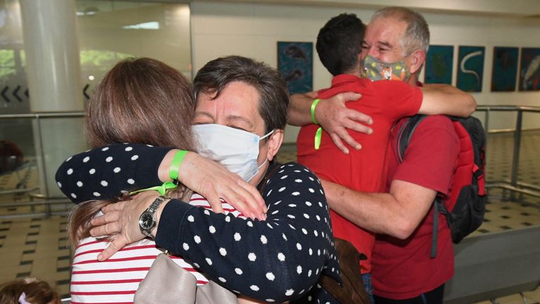 Julianna and Rudolf Nemeth from Hungary are reunited with their daughter and son-in-law Zsofi and David Kaityafter as they arrive on the first international flight to the Brisbane International Airport, after Australia reopened its international borders to travelers vaccinated against the coronavirus disease (COVID-19), in Brisbane, Australia Monday, February 21, 2022. AAP Image/Darren England via REUTERS ATTENTION EDITORS - THIS IMAGE WAS PROVIDED BY A THIRD PARTY. NO RESALES. NO ARCHIVE. AUSTR