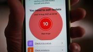 A message to self-isolate, with ten days of required self-isolation remaining, is displayed on the NHS coronavirus contact tracing app on a mobile phone, in London. Picture date: Tuesday August 3, 2021.