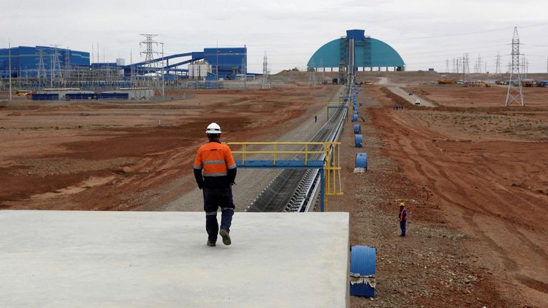 FILE PHOTO: An employee looks at the Oyu Tolgoi mine in Mongolia's South Gobi region June 23, 2012. 