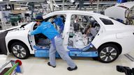 mployee of Toyota Motor Corp. pushes a body unit of a Mirai fuel cell vehicle (FCV) on it's assembly line at the company's Motomachi plant in Toyota, Aichi prefecture, Japan May 17, 2018