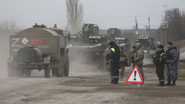 Russian Army military vehicles drive along a street, after Russian President Vladimir Putin authorized a military operation in eastern Ukraine, in the town of Armyansk, Crimea, February 24, 2022. REUTERS/Stringer
