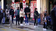 Boxing Day shoppers queue to enter shops in the centre of Cardiff, Wales, as new Covid-19 rules come into force. Groups of no more than six people will be allowed to meet in pubs, cinemas and restaurants in Wales, with two-metre social distancing being required in public premises and offices. Picture date: Sunday December 26, 2021.