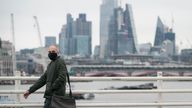 A person wearing a face mask crosses Waterloo Bridge, in London, as Plan B measures are lifted in England. Face coverings will no longer be mandatory in any setting, and the NHS Covid Pass will no longer be compulsory for entry into nightclubs and other large venues. Picture date: Thursday January 27, 2022.