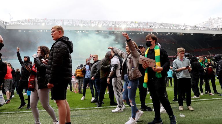 Soccer Football - Manchester United fans protest against their owners before the Manchester United v Liverpool Premier League match - Manchester, Britain - May 2, 2021 Manchester United fans on the pitch in protest against their owners before the match Action Images via REUTERS/Carl Recine