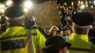 A woman holds up a placard as people gather in Clapham Common, London, after the Reclaim These Streets vigil for Sarah Everard was officially cancelled