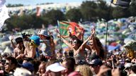 In this Sunday, June 30, 2019 file photo, revellers react to Kylie Minogue as she performs at the Glastonbury Festival, Somerset, England. One of Britain's biggest summer music events, the Glastonbury Festival, has been canceled Wednesday, March, 18 2020, because of the coronavirus pandemic. Organizers say the festival, due to take place June 24-28, will be postponed until 2021 (Photo by Grant Pollard/Invision/AP, File)