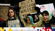 People hold placards during a pro-Ukrainian demonstration outside the Russian Embassy, in London, Britain February 23, 2022. REUTERS/Peter Nicholls