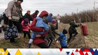 People fleeing the Russian invasion of Ukraine walk towards their transport helicopter after arriving in Slovakia, at a border crossing in Velke Slemence, Slovakia, March 5, 2022. REUTERS/Lukasz Glowala