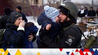 A police officer says goodbye to his son as his family flees from advancing Russian troops as Russia's attack on Ukraine continues in the town of Irpin outside Kyiv, Ukraine, March 8, 2022. REUTERS/Thomas Peter
