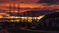 Jackup rigs, used in the North Sea oil and gas industry, are silhouetted against the sky at sunset over the Port of Dundee in the Firth of Tay, Dundee.