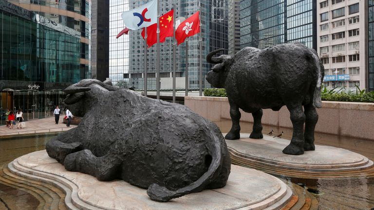 The Hong Kong Exchanges flag, Chinese national flag and Hong Kong flag are hoisted outside the Hong Kong Stocks Exchange in Hong Kong June 7, 2016. REUTERS/Bobby Yip/File Photo