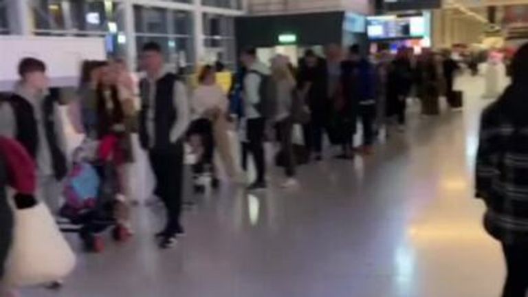 Passengers queue at manchester airport as staff try to keep up with demand. 