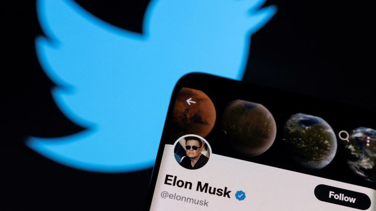 Elon Musk's twitter account is seen on a smartphone in front of the Twitter logo in this photo illustration taken, April 15, 2022. REUTERS/Dado Ruvic/Illustration
