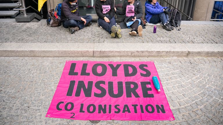 Activists from Extinction Rebellion block an entrance to Lloyds of London, in the City of London, as they call for Lloyds to stop insuring fossil fuel projects worldwide. Picture date: Tuesday April 12, 2022.