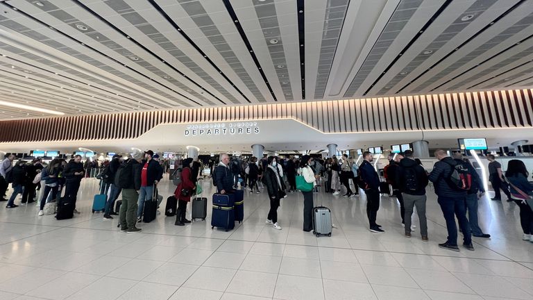 Passengers queue for security screening in the departures area of Terminal 2 at Manchester Airport in Manchester, Britain April 4, 2022. REUTERS/Phil Noble
