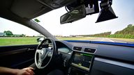 HANOVER, GERMANY - JUNE 20: A driver presents a Cruising Chauffeur, a hands free self-driving system designed for motorways during a media event by Continental to showcase new automotive technologies on June 20, 2017 in Hannover, Germany. The company presented new clean diesel technology, cable-less and other advances in electric car charging, smartphone technology for rental cars, driverless car advances and robotic taxi services. (Photo by Alexander Koerner/Getty Images)