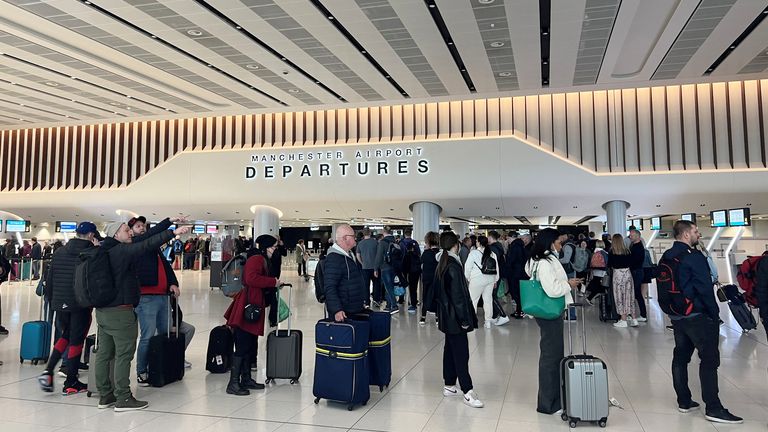 Passengers queue for security screening in the departures area of Terminal 2 at Manchester Airport in Manchester, Britain April 4, 2022. REUTERS/Phil Noble
