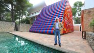 Bulgarian artist Christo poses in front of the monumental "Mastaba" art work at the Maeght Foundation (Fondation Maeght) on the opening day of the exibition on June 4, 2016 in Saint-Paul-de-Vence, southeastern France