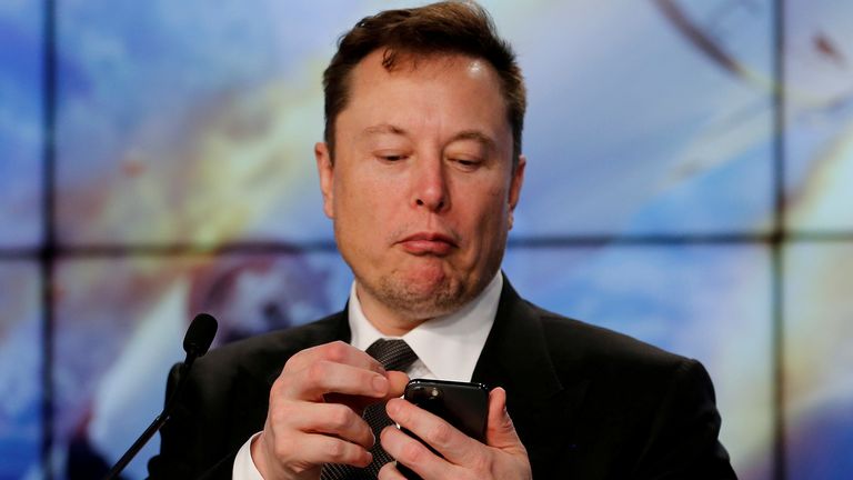 FILE PHOTO: SpaceX founder and chief engineer Elon Musk looks at his mobile phone during a post-launch news conference to discuss the SpaceX Crew Dragon astronaut capsule in-flight abort test at the Kennedy Space Center in Cape Canaveral, Florida, U.S. January 19, 2020. REUTERS/Joe Skipper/File Photo
