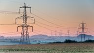 Electricity pylons and lines above farmland , England