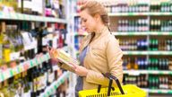 woman buying wine in the supermarket

