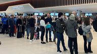 Passengers queue for security screening in the departures area of Terminal 2 at Manchester Airport in Manchester, Britain April 4, 2022. REUTERS/Phil Noble
