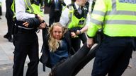 An activist is carried away by police officers at an Extinction Rebellion protest outside Shell's headquarters in London, Britain, April 13, 2022. REUTERS/Hannah McKay
