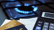 bank cards and a calculator on the background of a burning plate