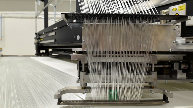 Fibre glass in a giant loom is pictured at the Open Hybrid Lab Factory, which is a research and development center of several companies like German car maker Volkswagen, during a media tour to present Volkswagen's so called 