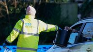 A member of NHS Test and Trace collects a sample from a member of the public at the drive-thru Covid-19 testing site on Hawkwood Road in Bournemouth. The UK Health Security Agency have said people in England without coronavirus symptoms who have a positive lateral flow test will no longer need a confirmatory PCR test from January 11. Picture date: Wednesday January 5, 2022.
