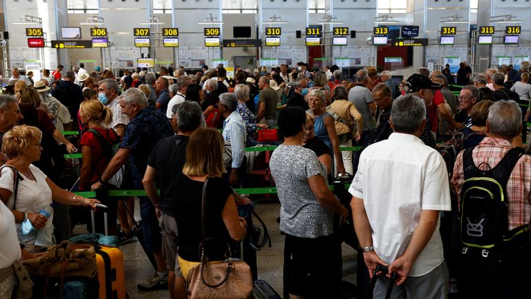 Passengers queue at check-in desks at Malaga-Costa del Sol Airport, in Malaga, Spain June 4, 2022. REUTERS/Jon Nazca