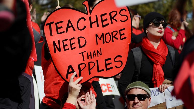 Munroe Elementary teacher Melissa Curry holds a sign during a rally across from the Colorado State Capitol as Denver public school teachers strike for a second day in Denver, Colorado, U.S., February 12, 2019. REUTERS/Michael Ciaglo