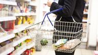 Woman with shopping basket at a supermarket

