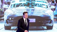 FILE PHOTO: Tesla Inc CEO Elon Musk walks next to a screen showing an image of Tesla Model 3 car during an opening ceremony for Tesla China-made Model Y program in Shanghai, China January 7, 2020. REUTERS/Aly Song/File Photo
