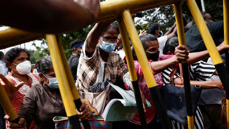 Members of Samagi Vanitha Balawegaya, a part of the main opposition party Samagi Jana Balawegaya, try to move a barrier during a protest near Sri Lanka's Prime Minister Ranil Wickremesinghe's private residence, amid the country's economic crisis, in Colombo, Sri Lanka, June 22, 2022. REUTERS/Dinuka Liyanawatte