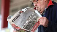 A racegoer reads the Racing Post newspaper at Redcar Racecourse. Picture date: Monday May 17, 2021.