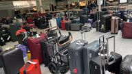 Unclaimed luggage standing in the baggage claim area of Heathrow's Terminal 3