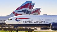 LONDON, ENGLAND - MARCH 2019: Boeing 777 long haul airliner operated by British Airways taxiing for take off at London Heathrow Airport past tail fins of the company's other aircraft.