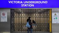 A rail passenger walks past a closed Tube station entrance in Victoria Station during the morning rush hour as the London Underground system is shut due to industrial action in London, Britain, March 1, 2022. REUTERS/Toby Melville
