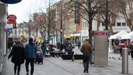 People make their way along the High street in Slough, Berkshire, in the final week of a four week national lockdown to curb the spread of coronavirus